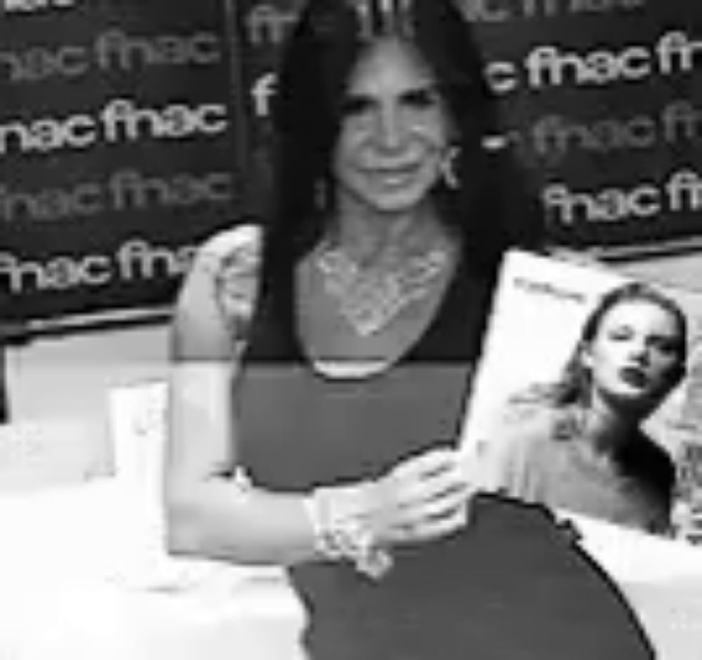 a black and white photo of a woman holding a book in front of a sign that says fnac .