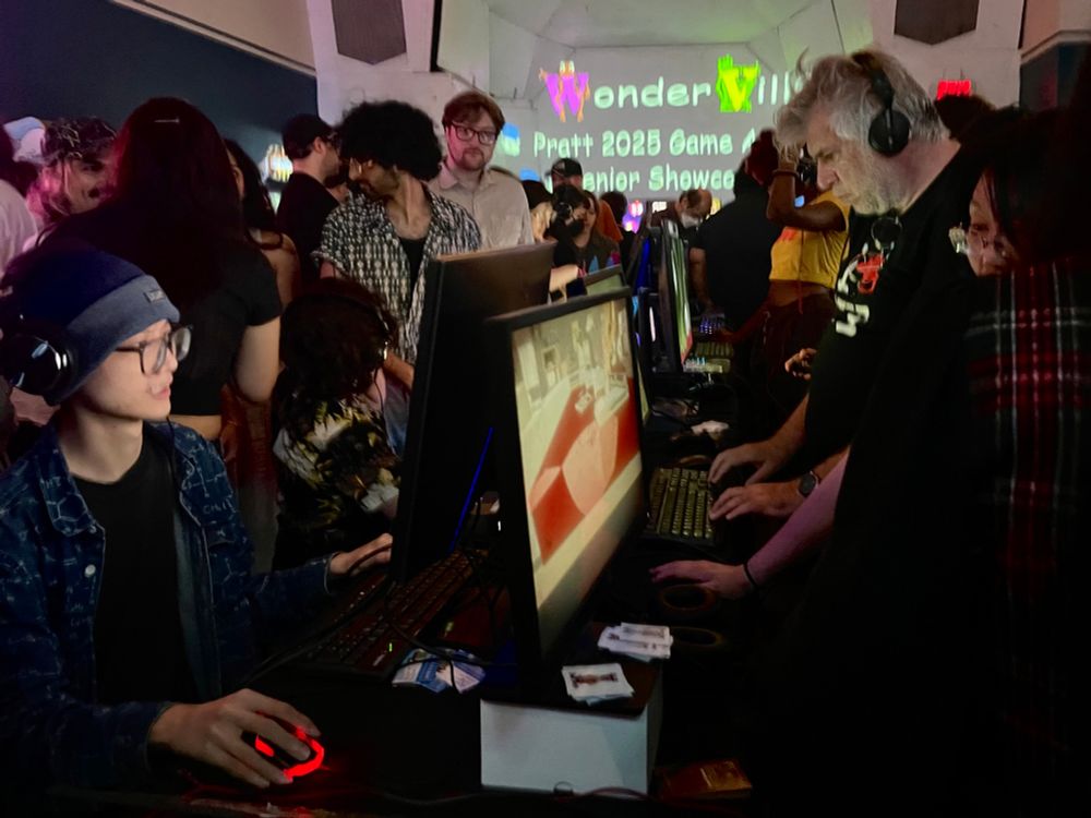 people sit down at monitors displaying a series of student games
