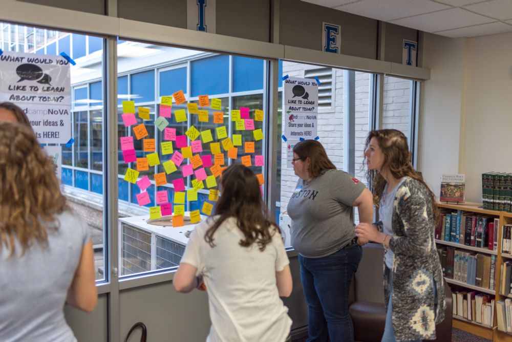 educators reviewing post-it notes on a window