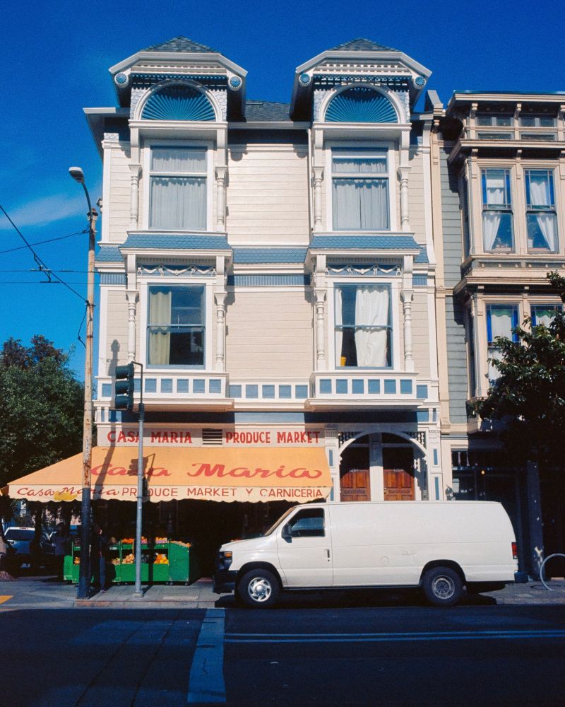 A market in the Mission District, with a sign that says “Casa Maria” and a white van in front of it. 