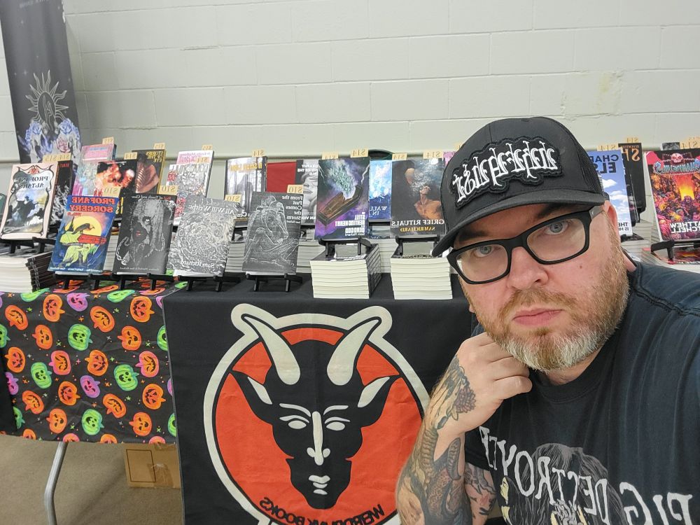A tired me in front of all the Weirdpunk releases displayed on a table.