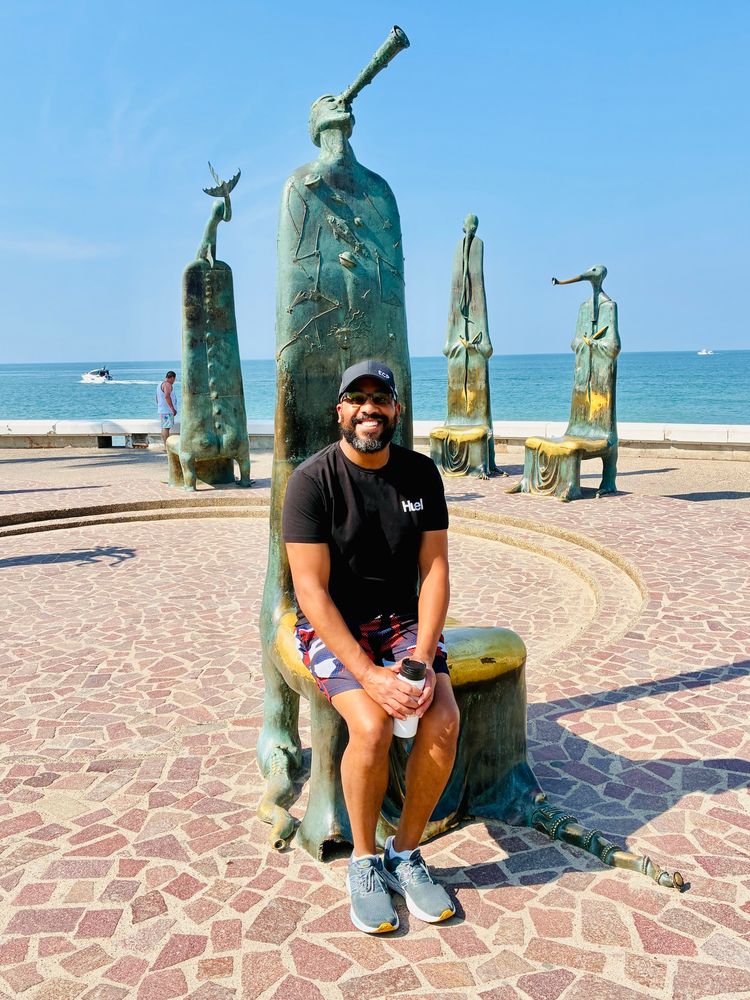 Me sitting on an a bronze astronomer statue / bench that is part of La Rotunda Del Mar on the Malécon.
