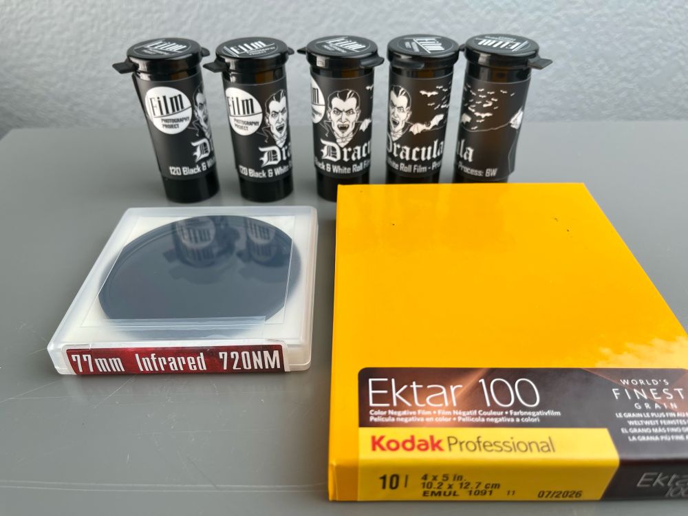 An assortment of camera film and an infrared filter