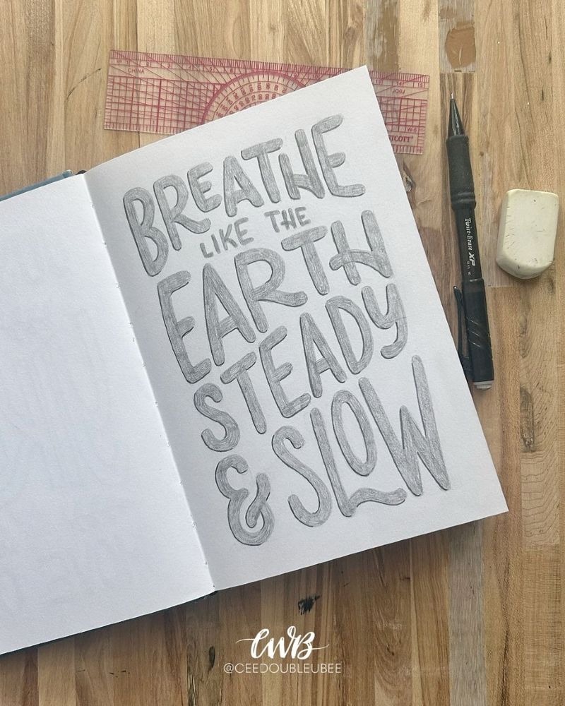 Calm, flowing sketch of rounded letters reading “Breathe Like the Earth, Steady and Slow.”
