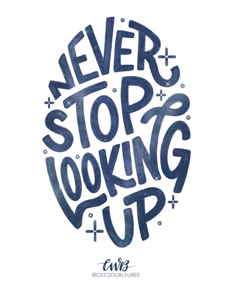 Hand lettered art for a sticker with the phrase “Never Stop Looking Up,” featuring swirling galaxy textures and stars inside the lettering.