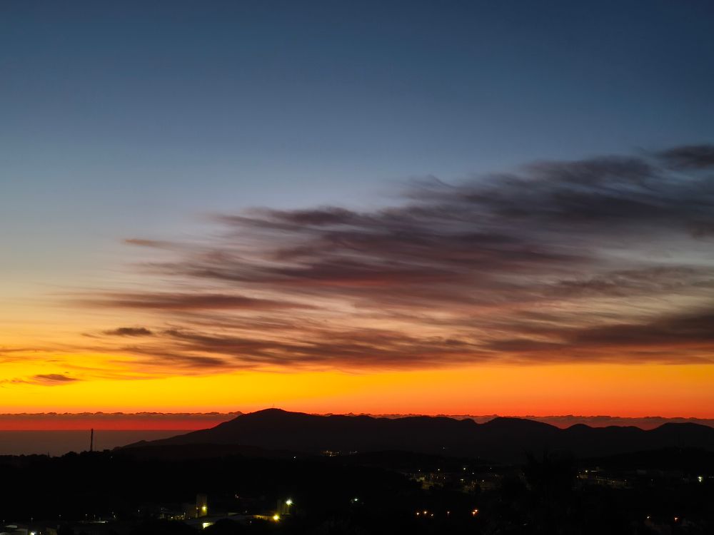 A dawn sky of pale citrusy colours and wisps of cloud above the Spanish Mediterranean. Taken on the Costa Blanca.