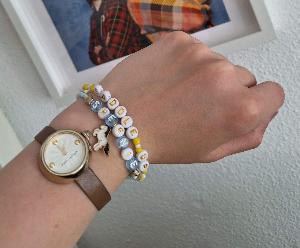 Picture of bracelet with the text Saddle Up Sheenie in reference to the comedy show Staged