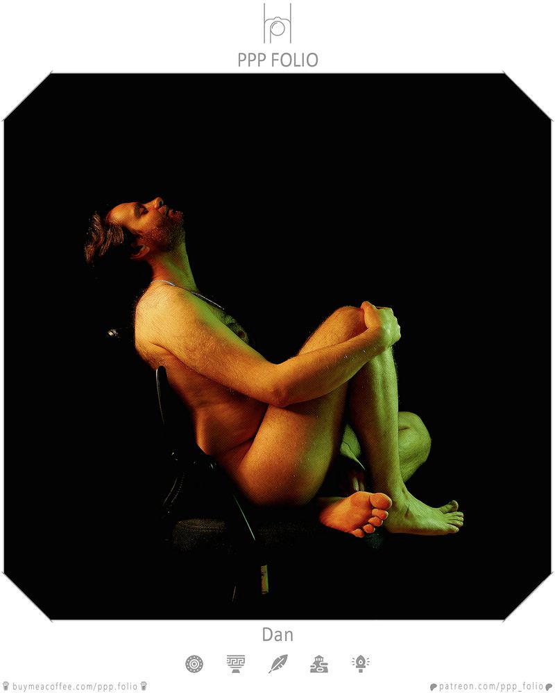 Colour gel lighting image of a side nude male model, sitting on a chair. 