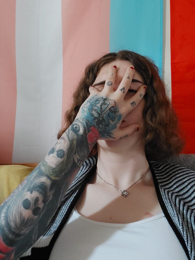 Selfie of Tucker, with her fiancé's hand grabbing her face