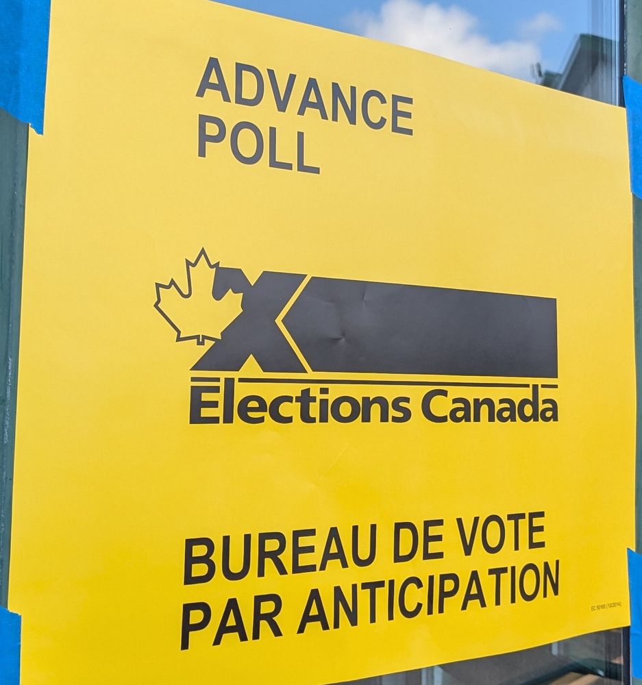 Yellow sign that says Advance Poll for Elections Canada. In English and French. 
