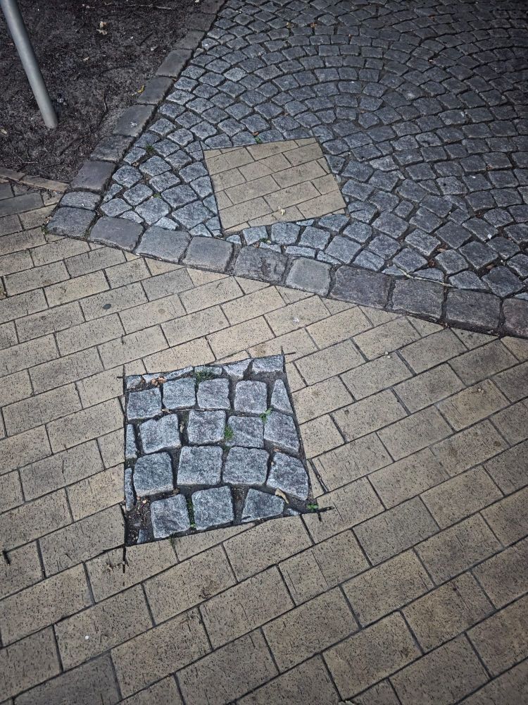a square of pavement misplaced (possibly intentionally)