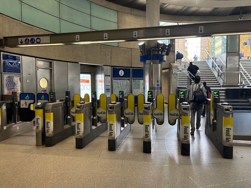 Gateline at Southwark tube wrapped in fossil Ads campaign. 