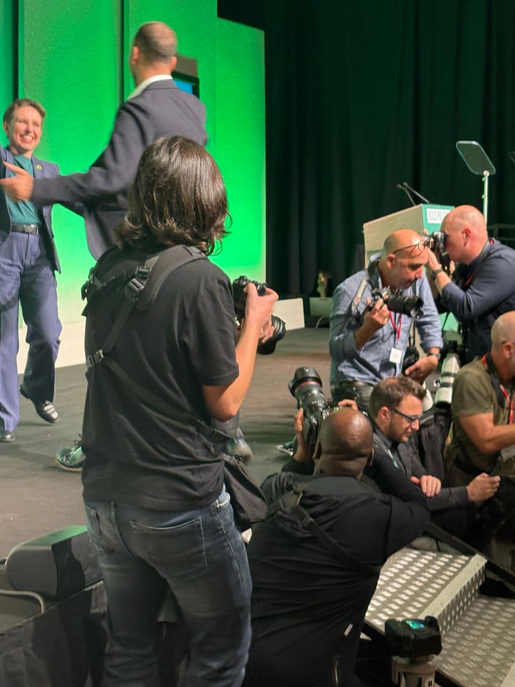 Carla handing over to Zack surrounded by press. 