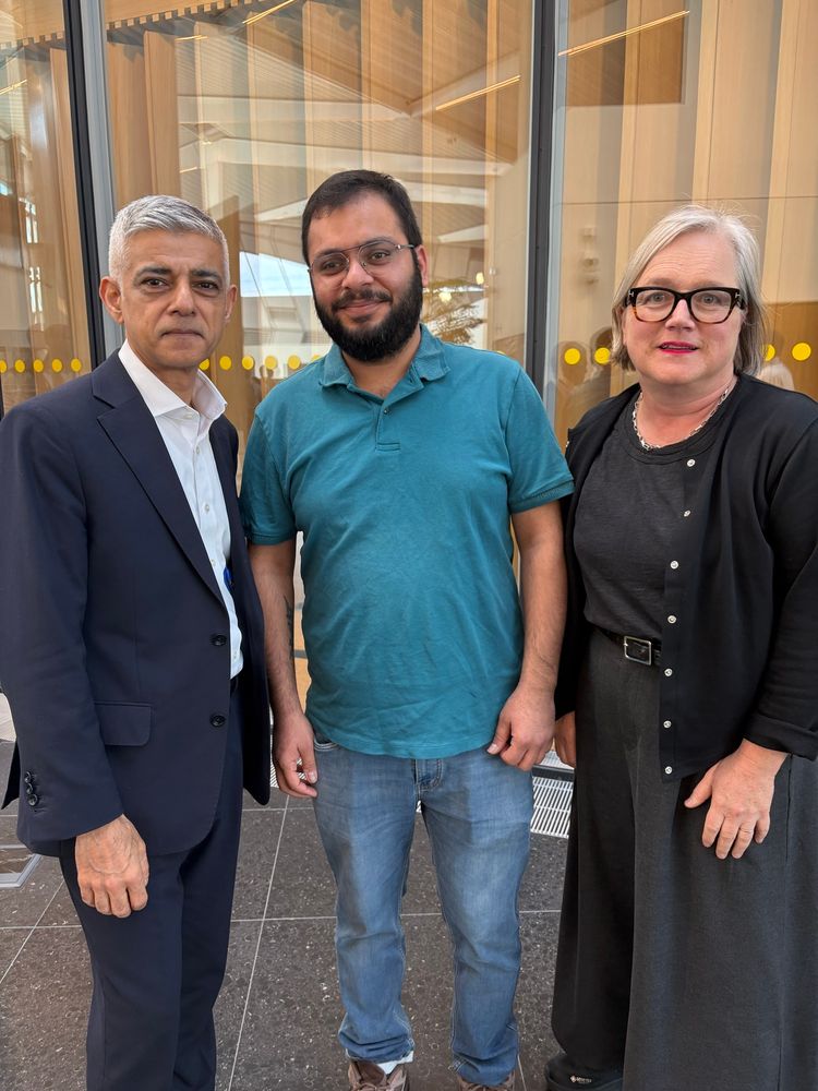 The Nayor with Avi, a TfL worker affected by govt visa changes, and Caroljne inside city hall. 