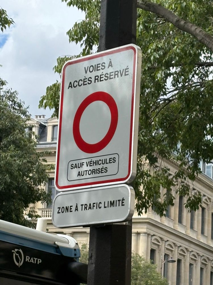 Sign for the new low traffic zone in central Paris. Red circle in white sign. 