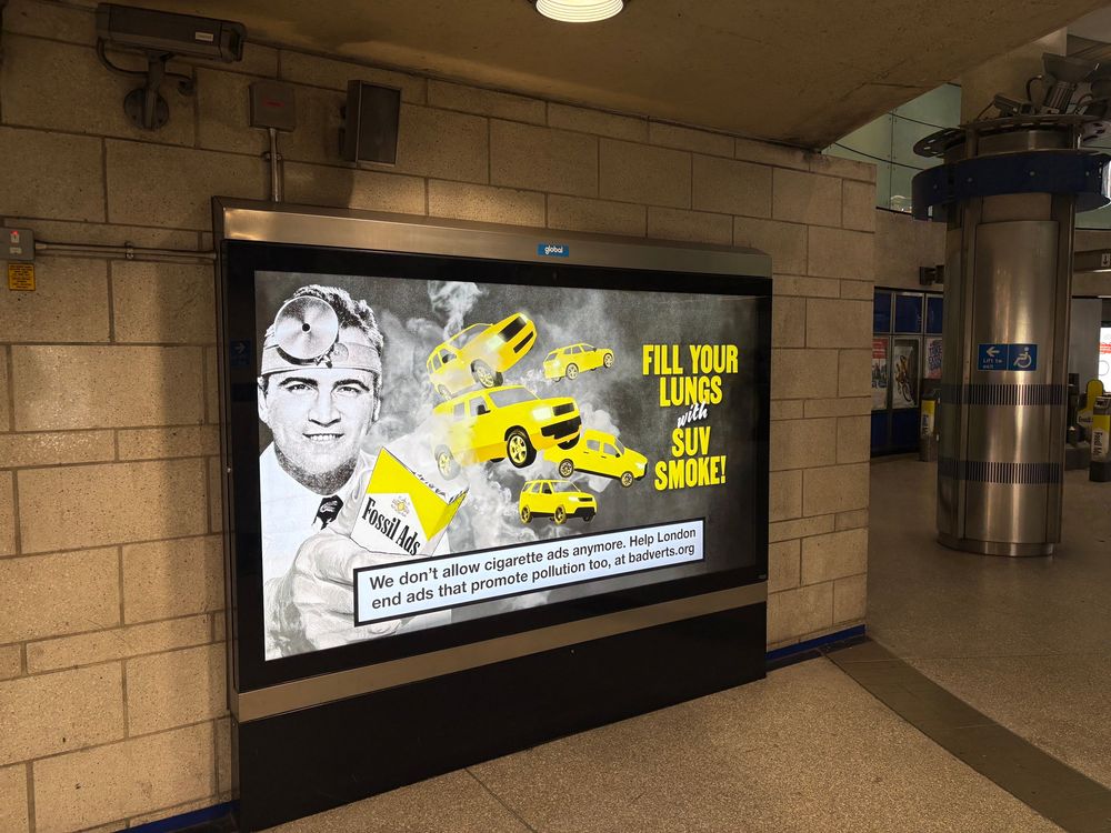 Fossil fuel advert “fill your lungs with SUV smoke!” At Southwark tube station. 