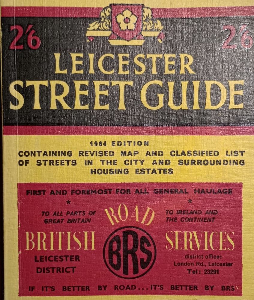 The front cover of the Leicester Street Guide for 1964.  It is black, red and yellow with the Leicester City Crest at the top. In the bottom part of the cover is an adverted for British Road Services. 