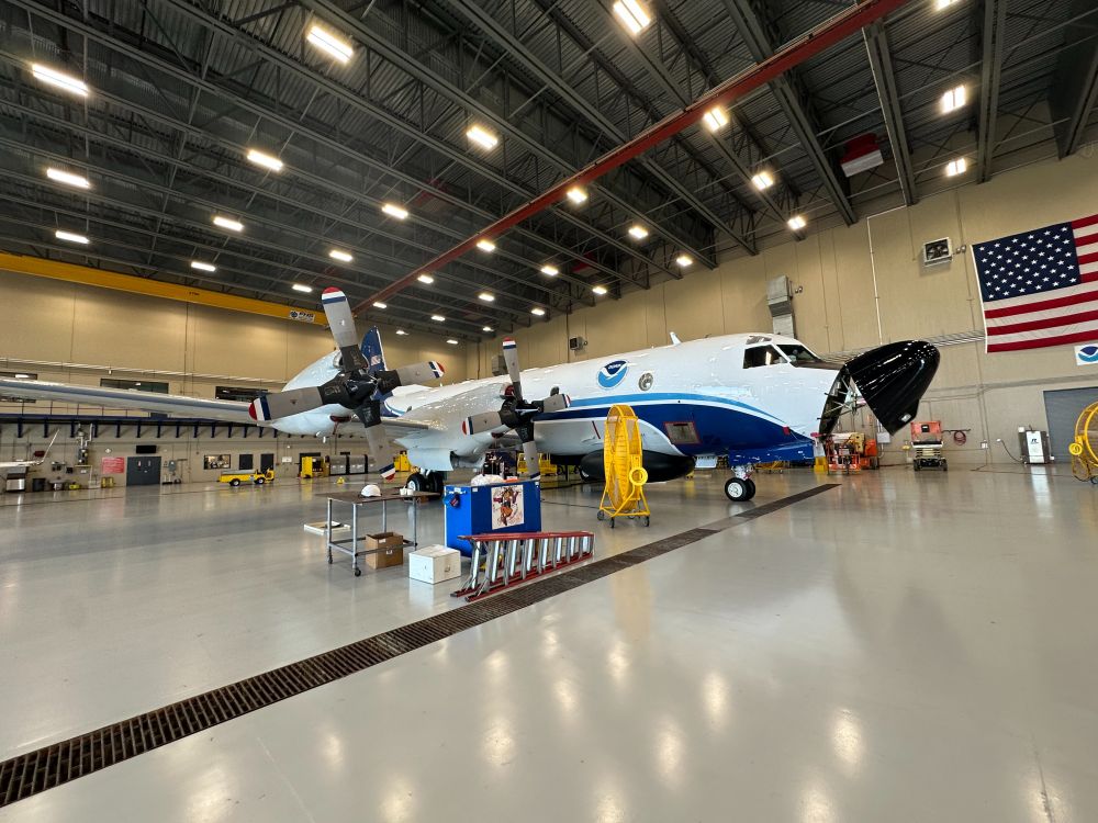 A large NOAA plane pictured in a hangar.