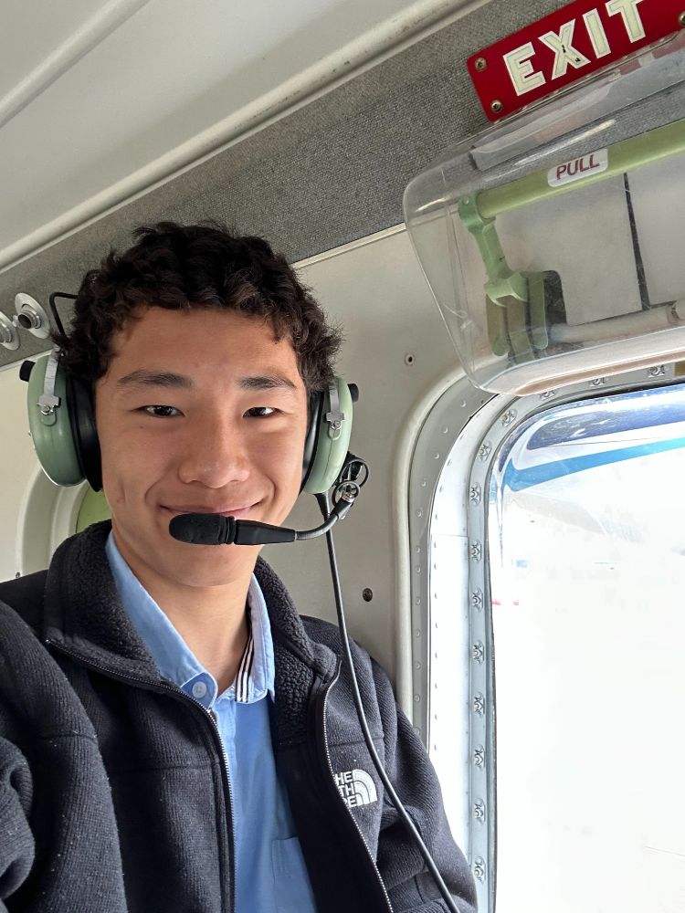 Michael Han sits in a plane wearing a headset.