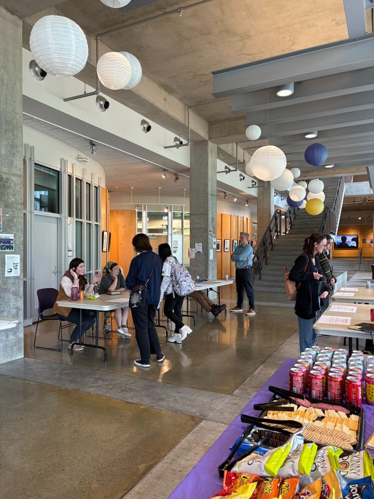 Undergraduates walk around the SAFS lobby speaking to graduate students and postdocs