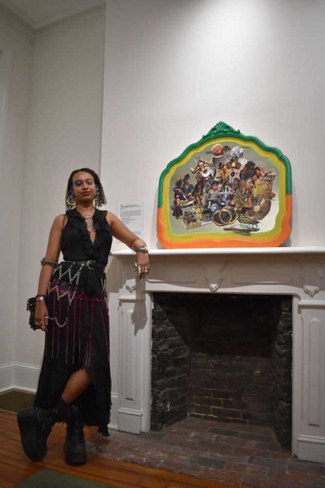 Artist SAFRA poses with their piece "The Land Remembers me so why don't you?"