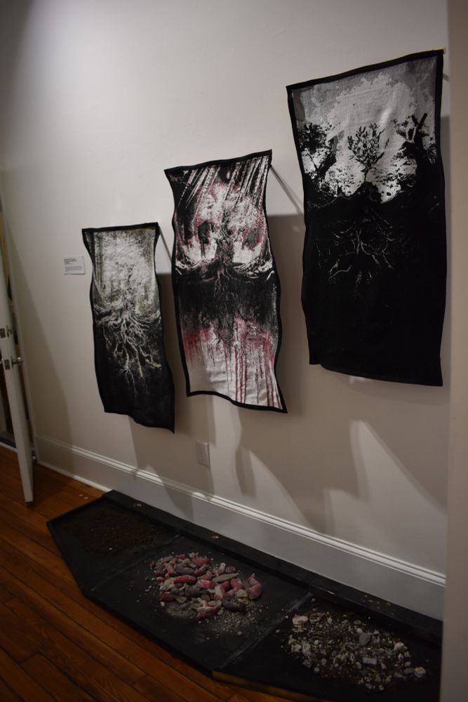Textile Tryptich-- “Destroying thier graves. Digging our own. - Free Palestine” featuring three images of olive trees, rubble and dirt. By Qamar Hassan and Loulie Rossmassler