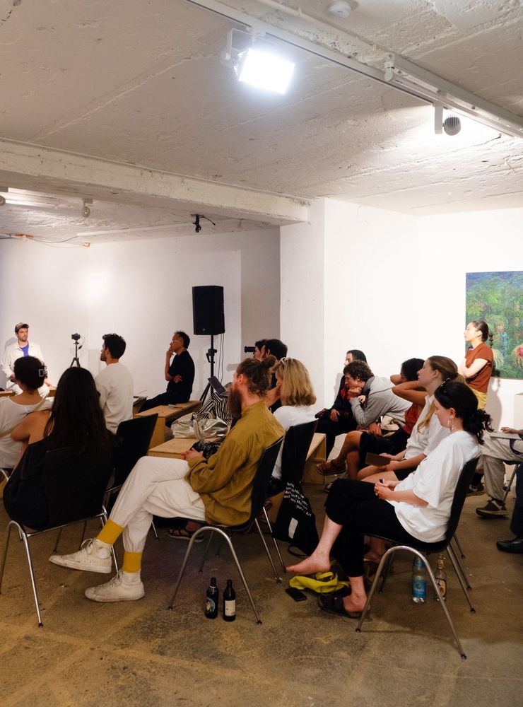 a group of people sitting in chairs in a room