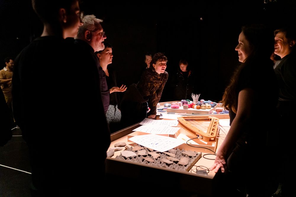 a group of people standing around a table with musical instruments