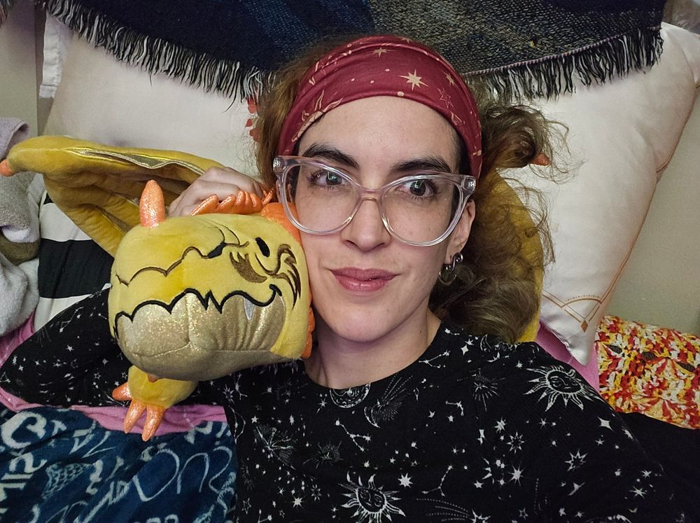 Ya bird laying on the couch with one of the gold weighted dragons on the shoulder