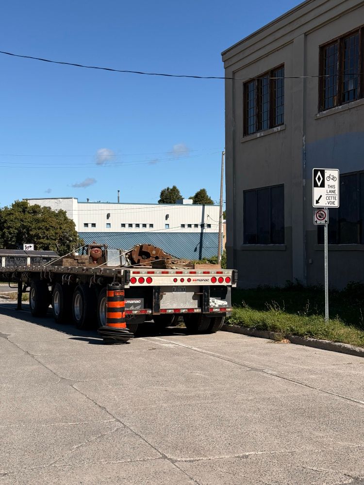 A trailer parked in a painted bike lane. 