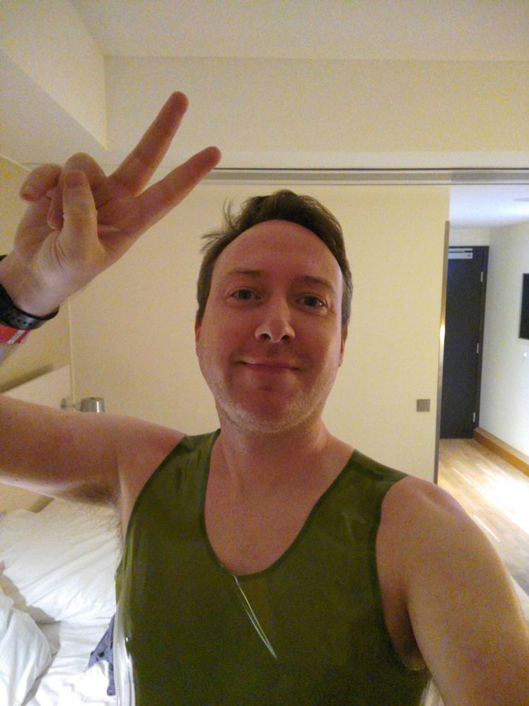Peace sign selfie in a latex top