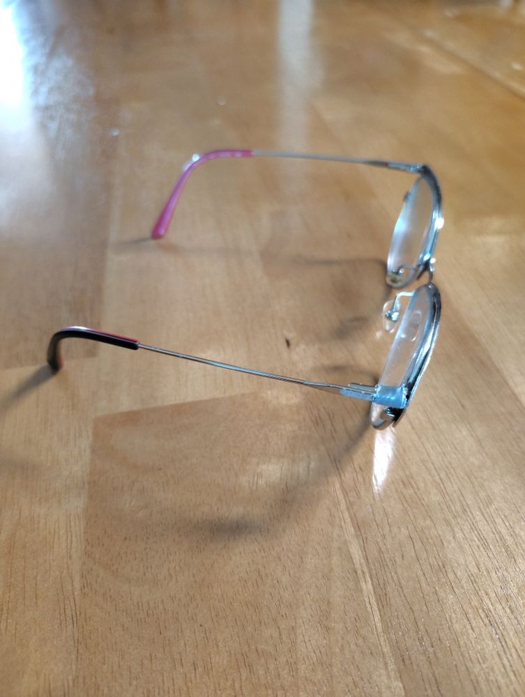 Formerly broken glasses vaguely duct taped together again