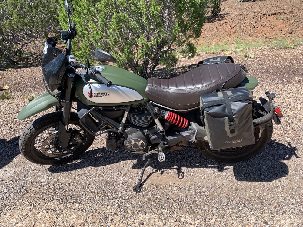 Green Scrambler Ducati Urban Enduro on an original part of Route 66 consisting of gravel. 