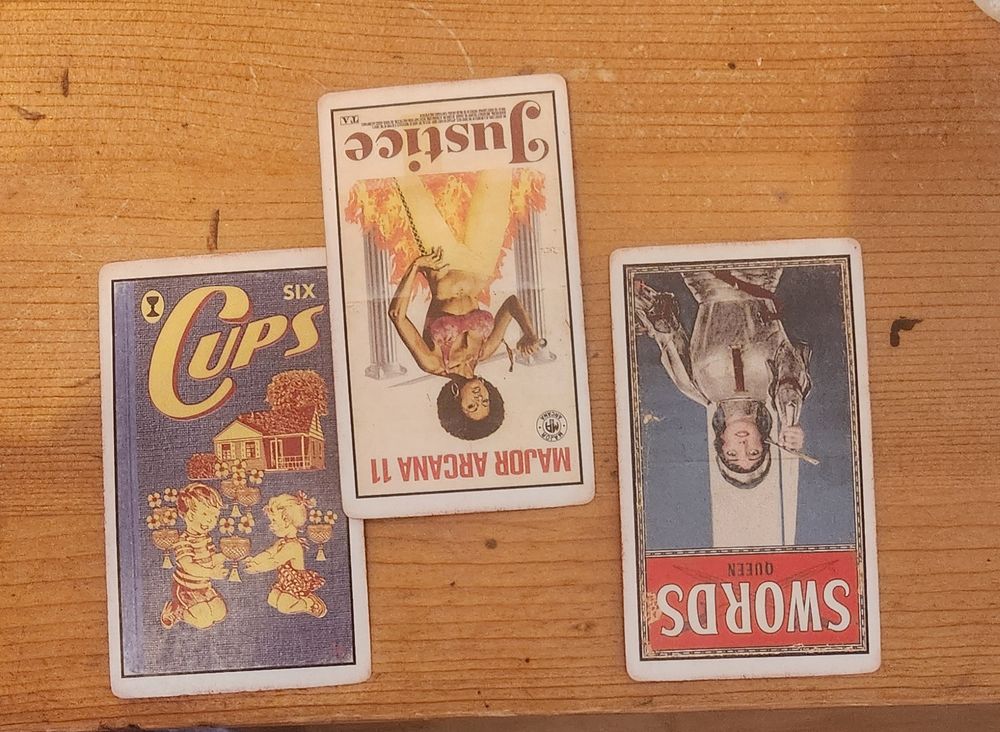 The Pulp Deck 6 of Cups has two children sharing a cup. Justice is a beautiful African American woman fighting for freedom and equality. The Queen of Swords is clad in armor as she raises her Sword.
