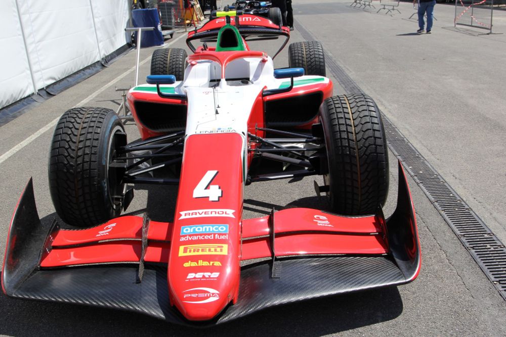Front-on view of the red and white Prema number 4 F2 car in the support paddock at Imola.