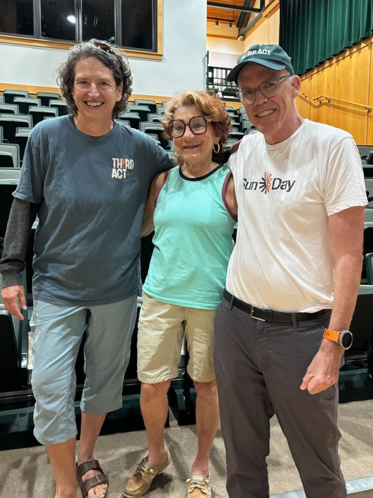 Upstate Third Actors and Bill McKibben pose in front of the auditorium seating.