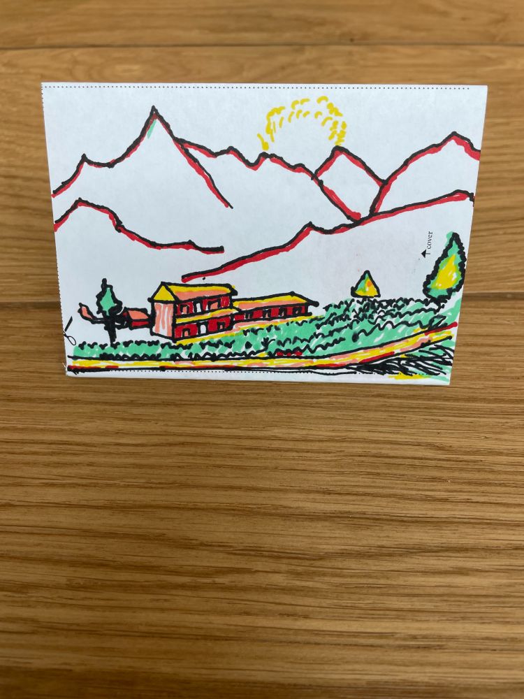 A zine with a scene of a house, farm and overlooking mountain range