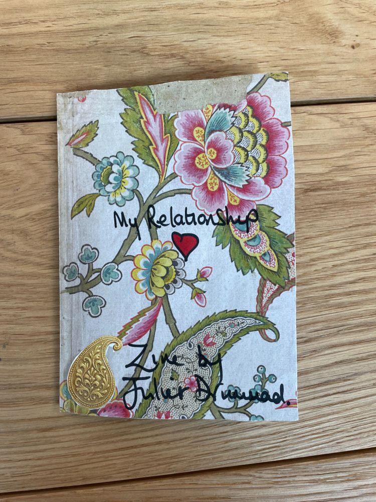A zine with a flowery background titled My Relationship by Juliet Drummad