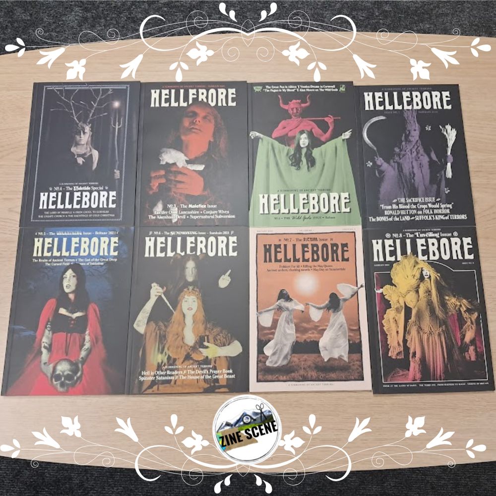 A photo of Hellebore issues 1-8 laid out on a table so all the covers are visible, with the zine scene logo.