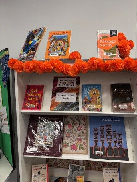 A close up photo of shelf covered in books all about South Asian Heritage.
