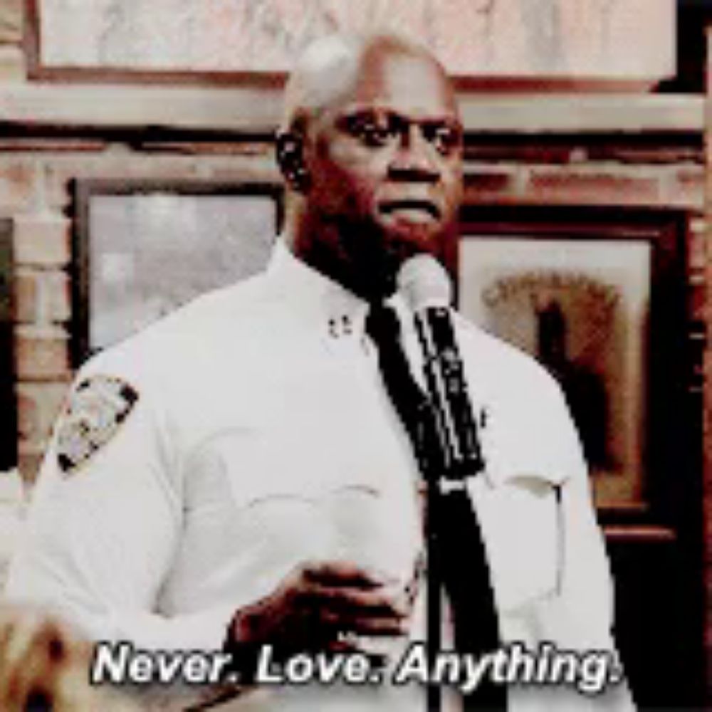 a man in a police uniform is speaking into a microphone while saying never love anything