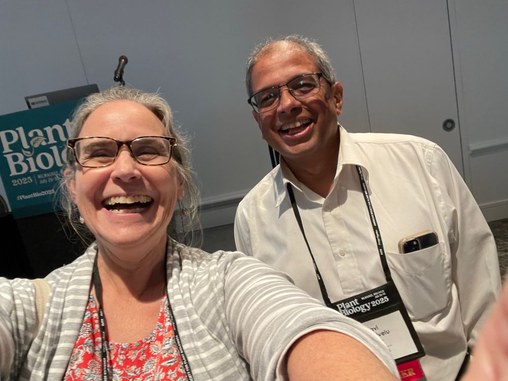 Two smiling people looking at the camera