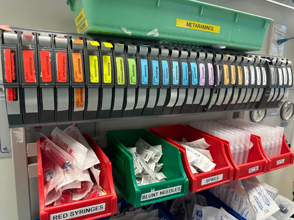Rack of anaesthetic stickers for syringes in colour order and with all the labels cut at the same level. 