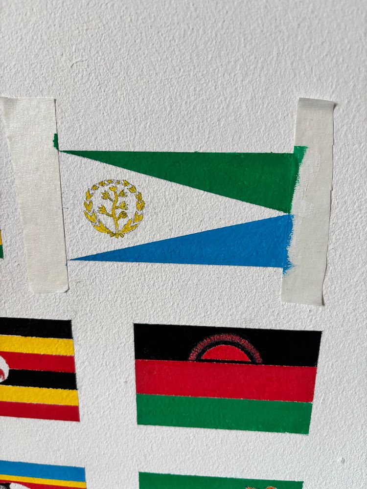 The partly-painted flag of Eritrea. The red is missing. Also in the photo is the flag of Malawi. 