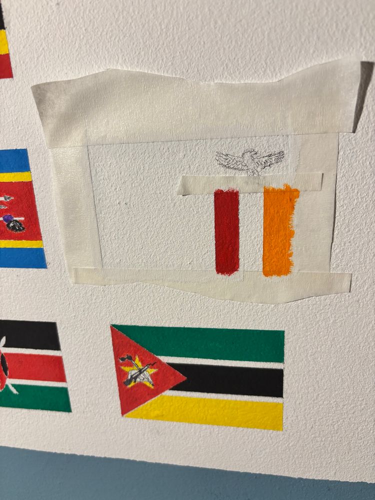 Partially-painted flag of Zambia, above the flag of Mozambique