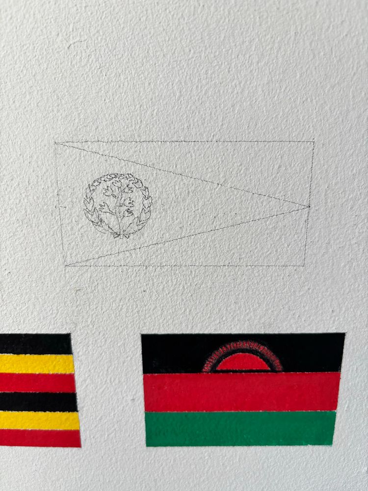 A pencil outline of the flag of Eritrea. Also in the photo is the flag of Malawi. 