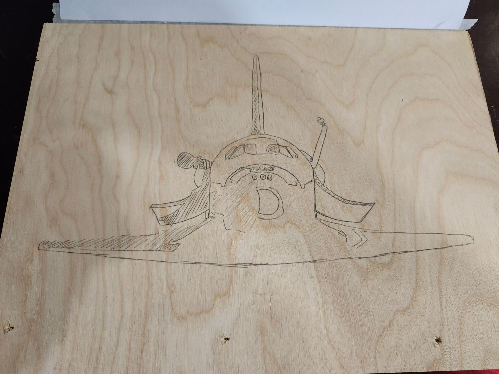 Sketch of a space shuttle on plywood