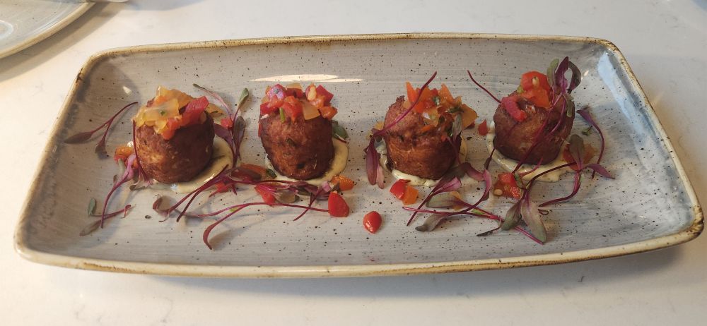 4 crab cakes shaped like tater tots. 