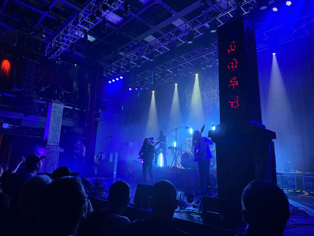 Blood Incantation concert pick with big obelisks on each side of the band.