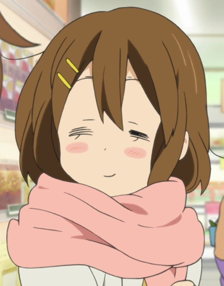 Yui smiling with her eyes closed, she is wearing a pink scarf